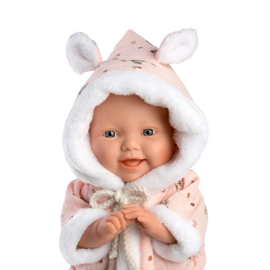Baby doll in a pink outfit with bunny ears on a white background