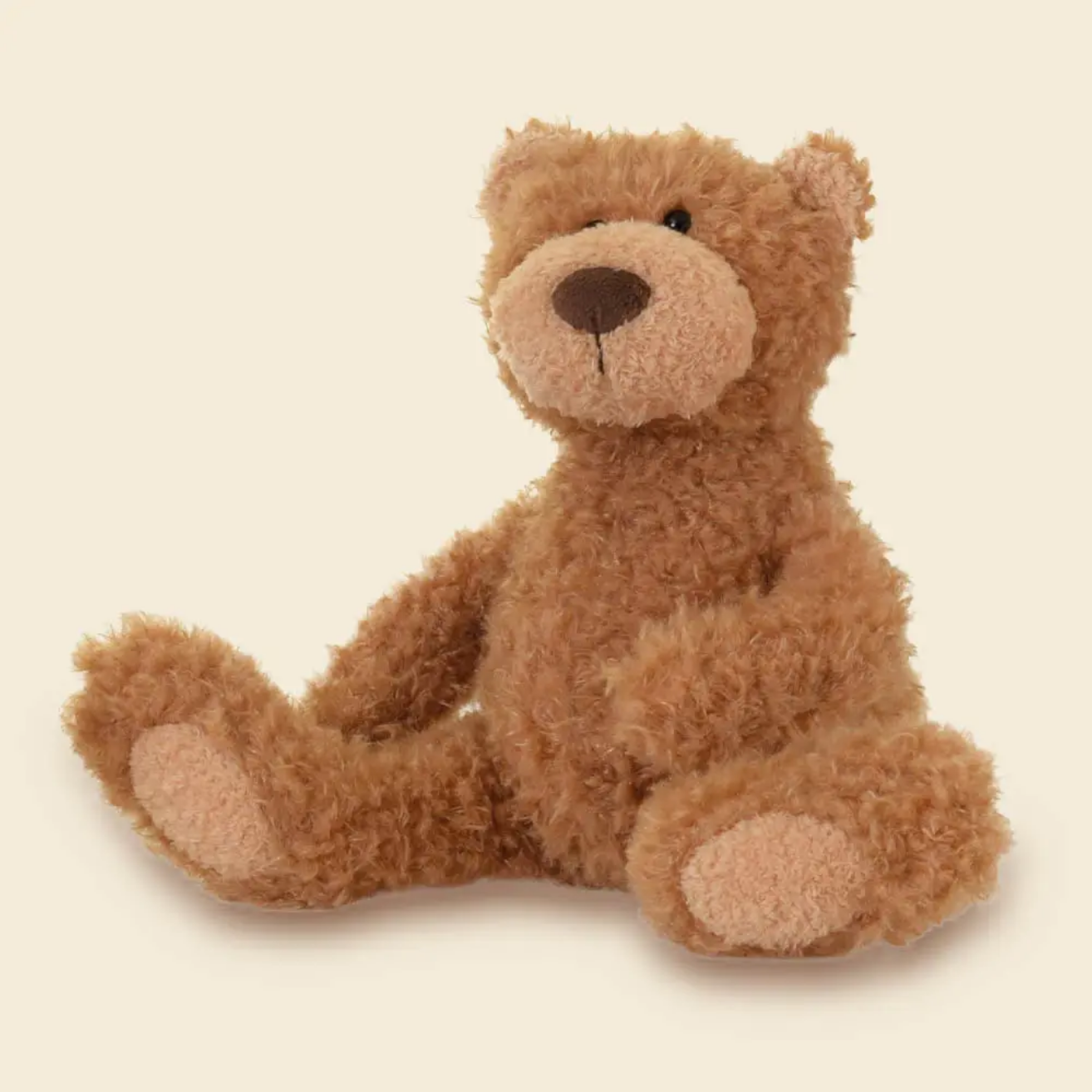 Brown teddy bear on a beige background
