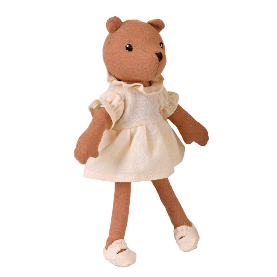 Stuffed teddy bear wearing a white dress on a white background