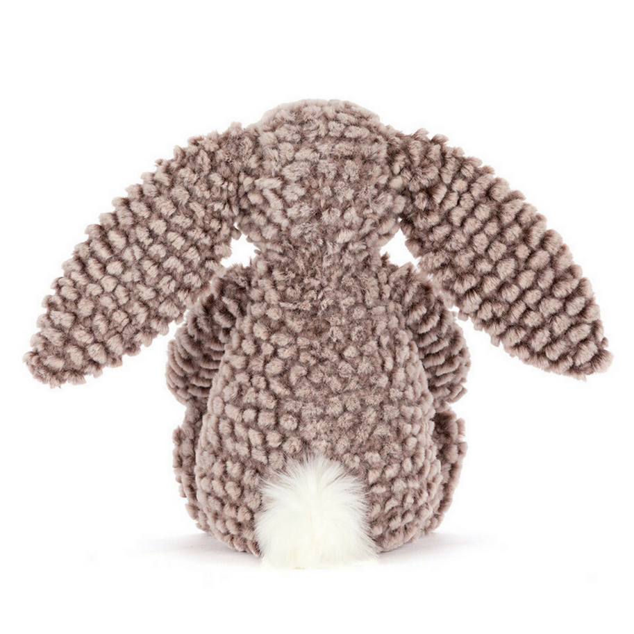 Stuffed bunny toy with textured fur on a white background
