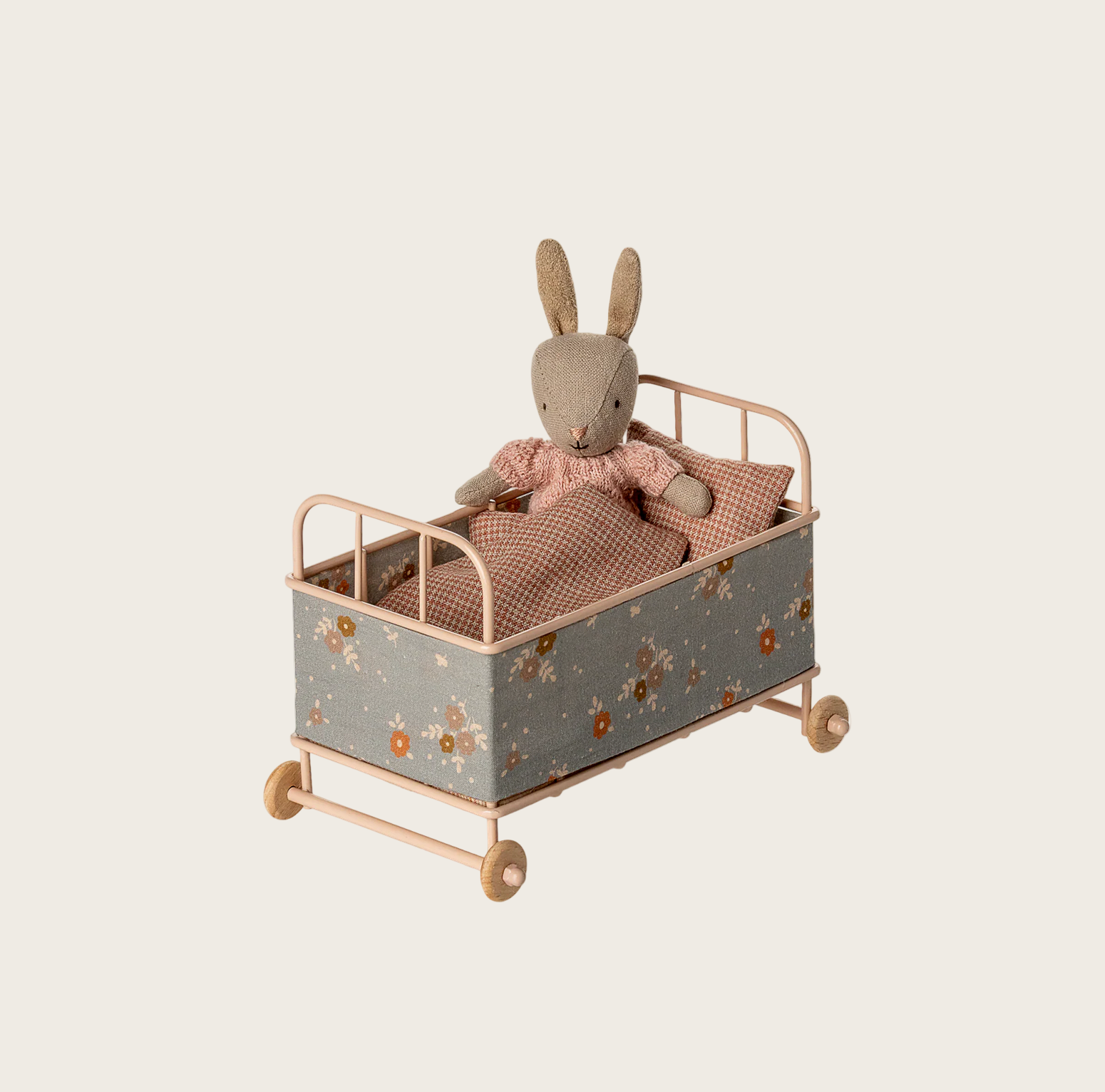 Toy rabbit in a decorative cart on a website page with product categories at the top.
