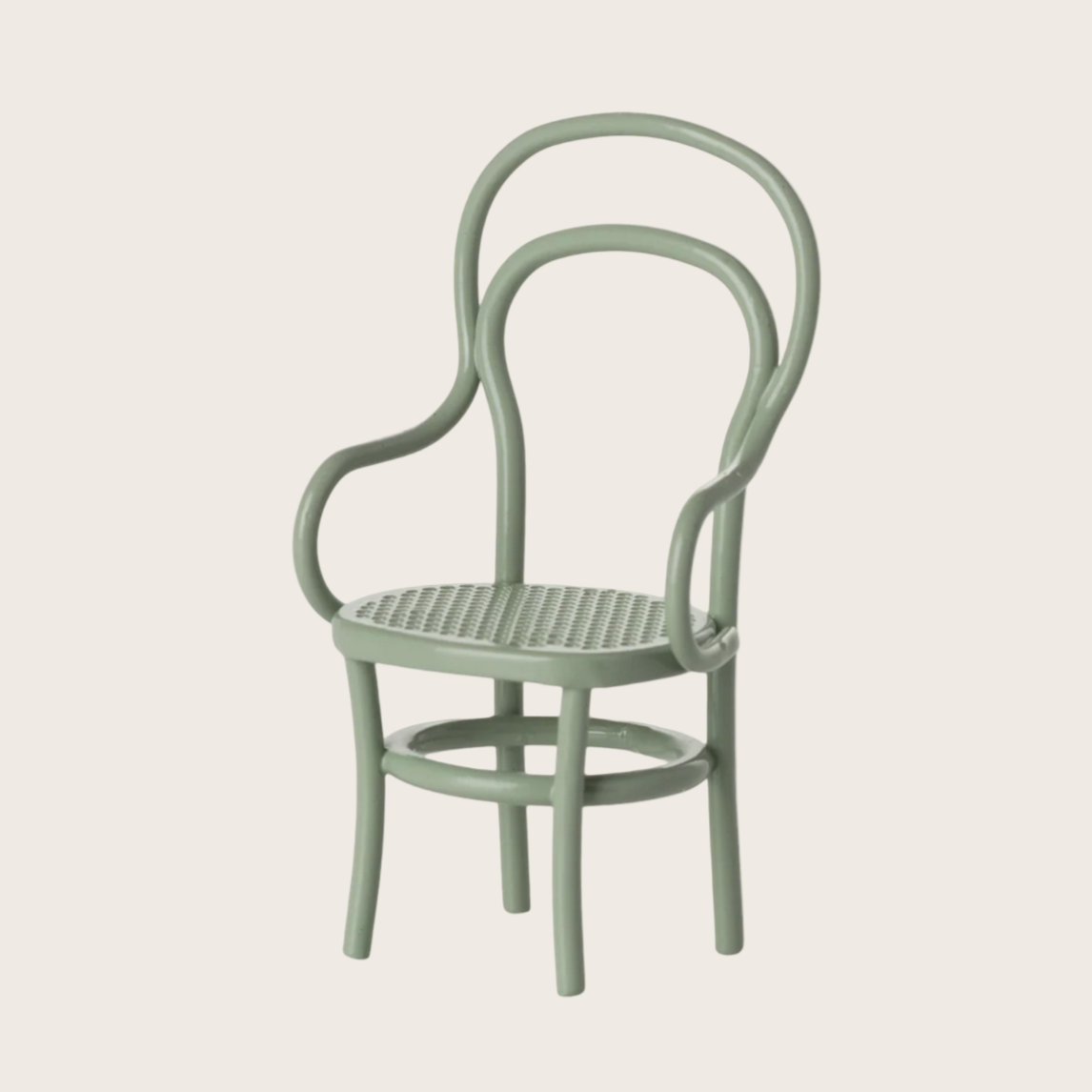 Green chair with thin metal frame on a light gray background