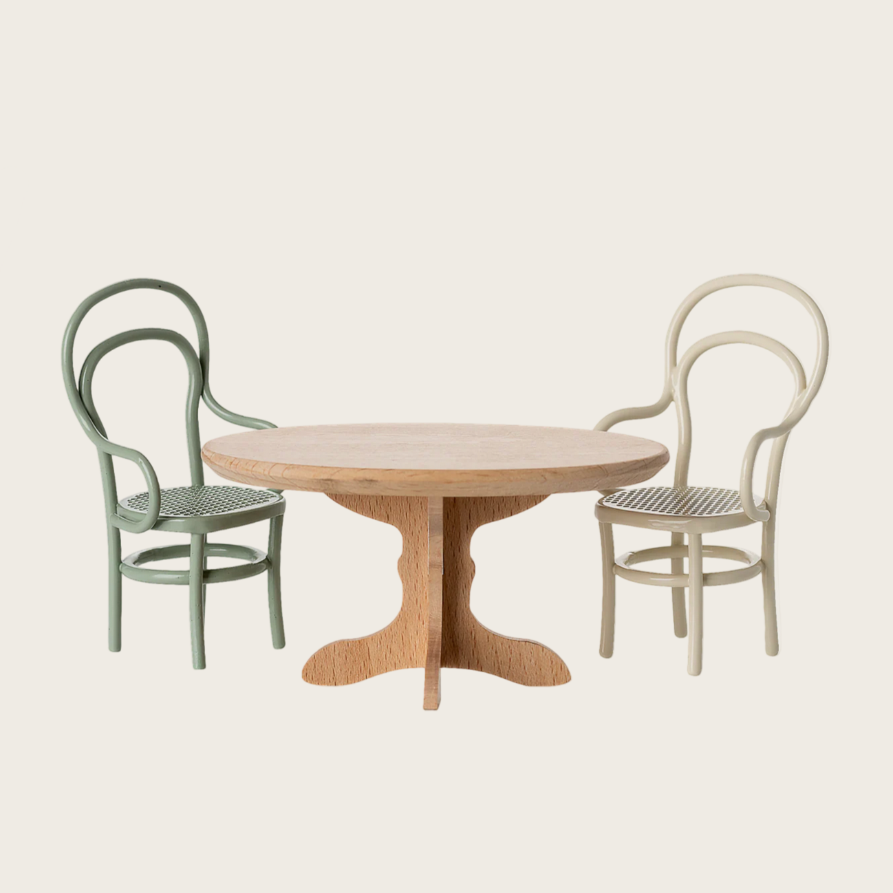 Round wooden table with two chairs on a light beige background