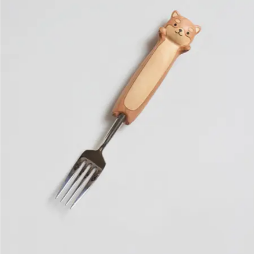 Fork with a dog-shaped handle on a light gray background