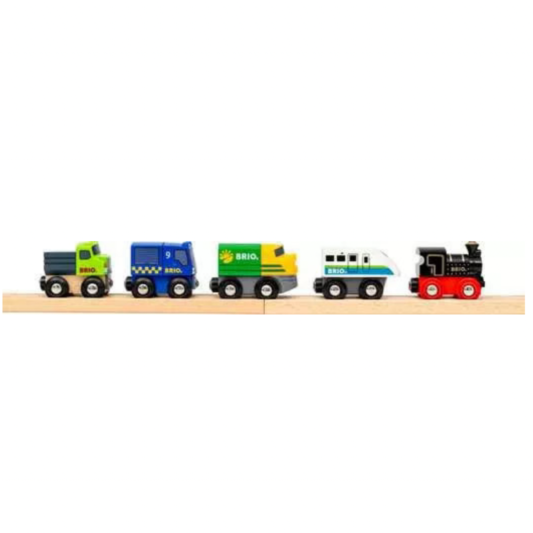 Set of colorful toy trucks and trains on a wooden track against a white background