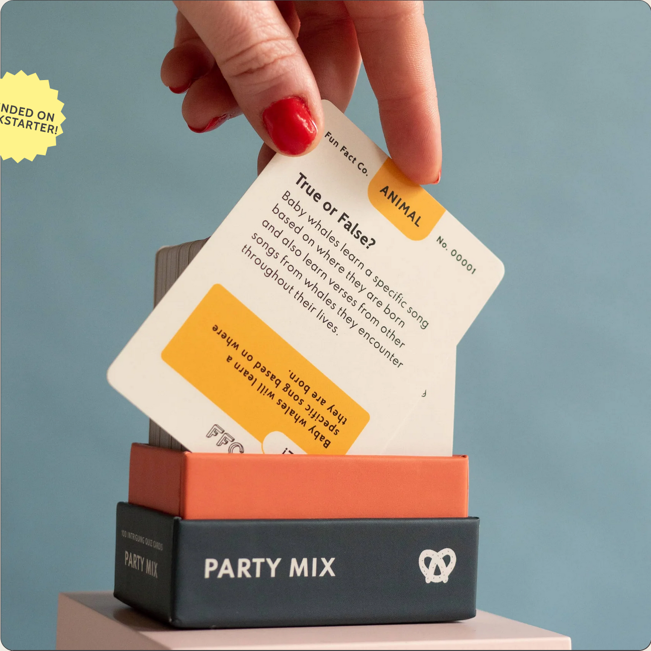 Hand holding a card over a 'Party Mix' box with a blue background