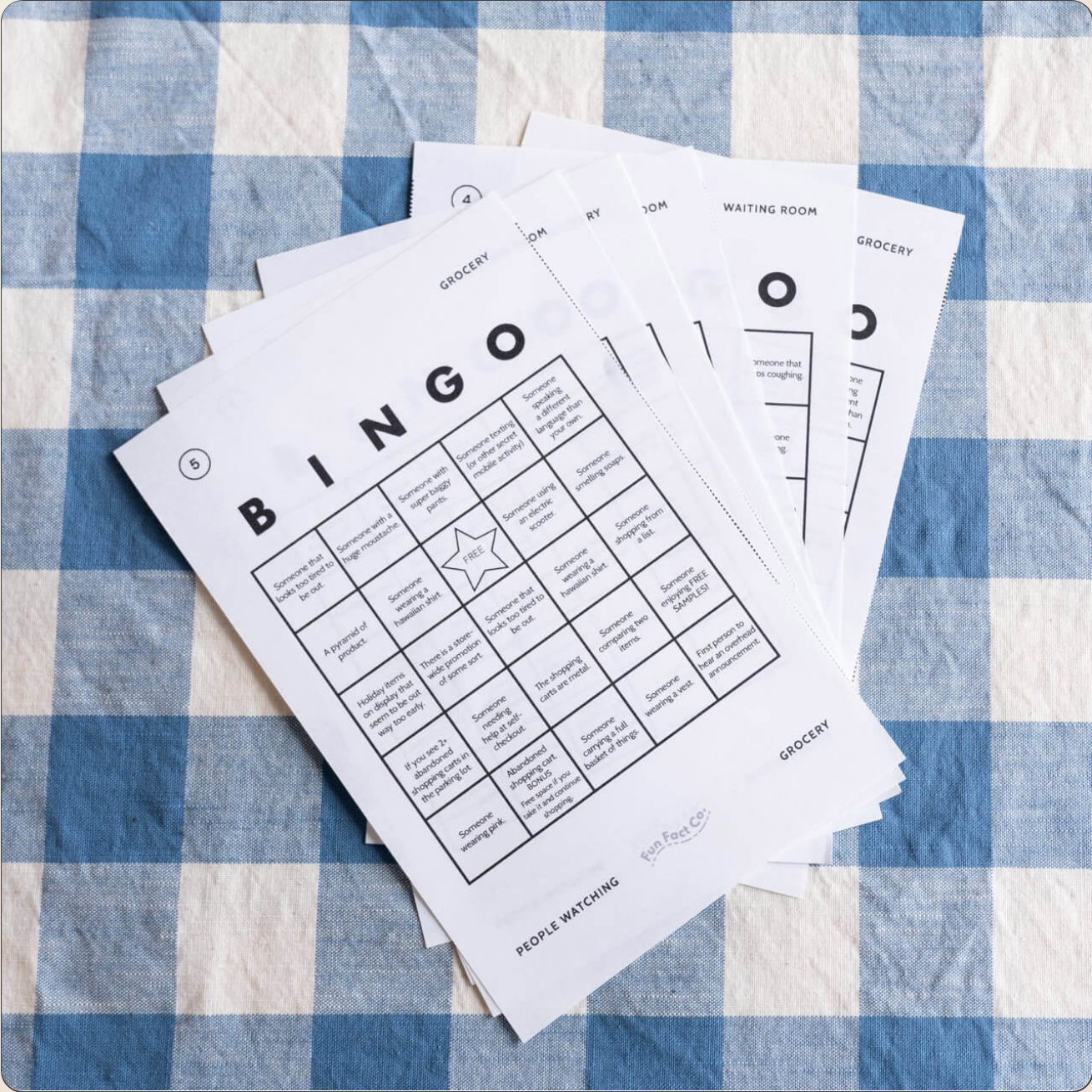 Bingo cards on a blue and white checkered tablecloth
