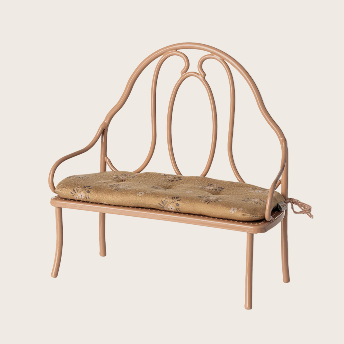 Vintage-style metal bench with cushion on a white background