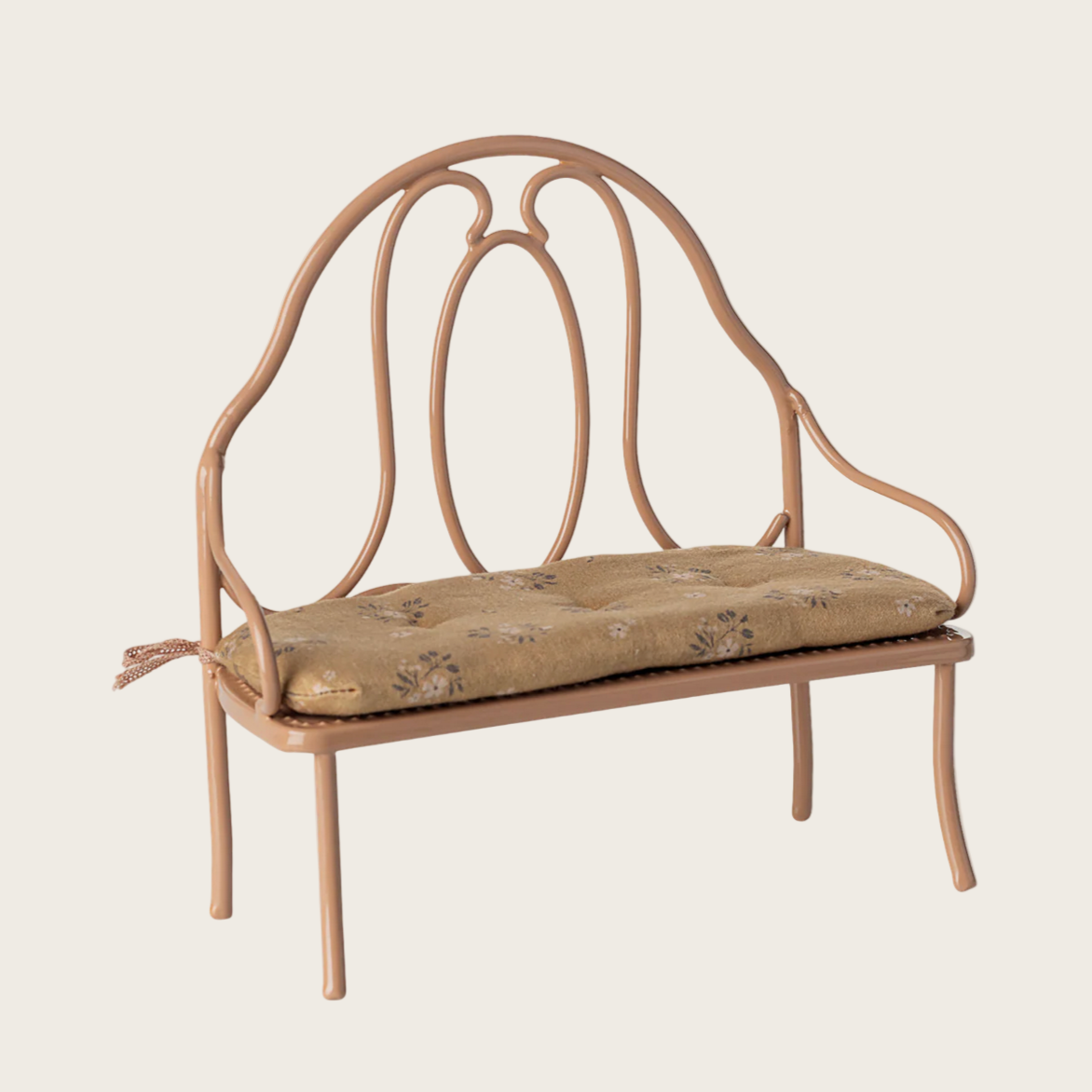 Vintage-style metal bench with cushion on a white background