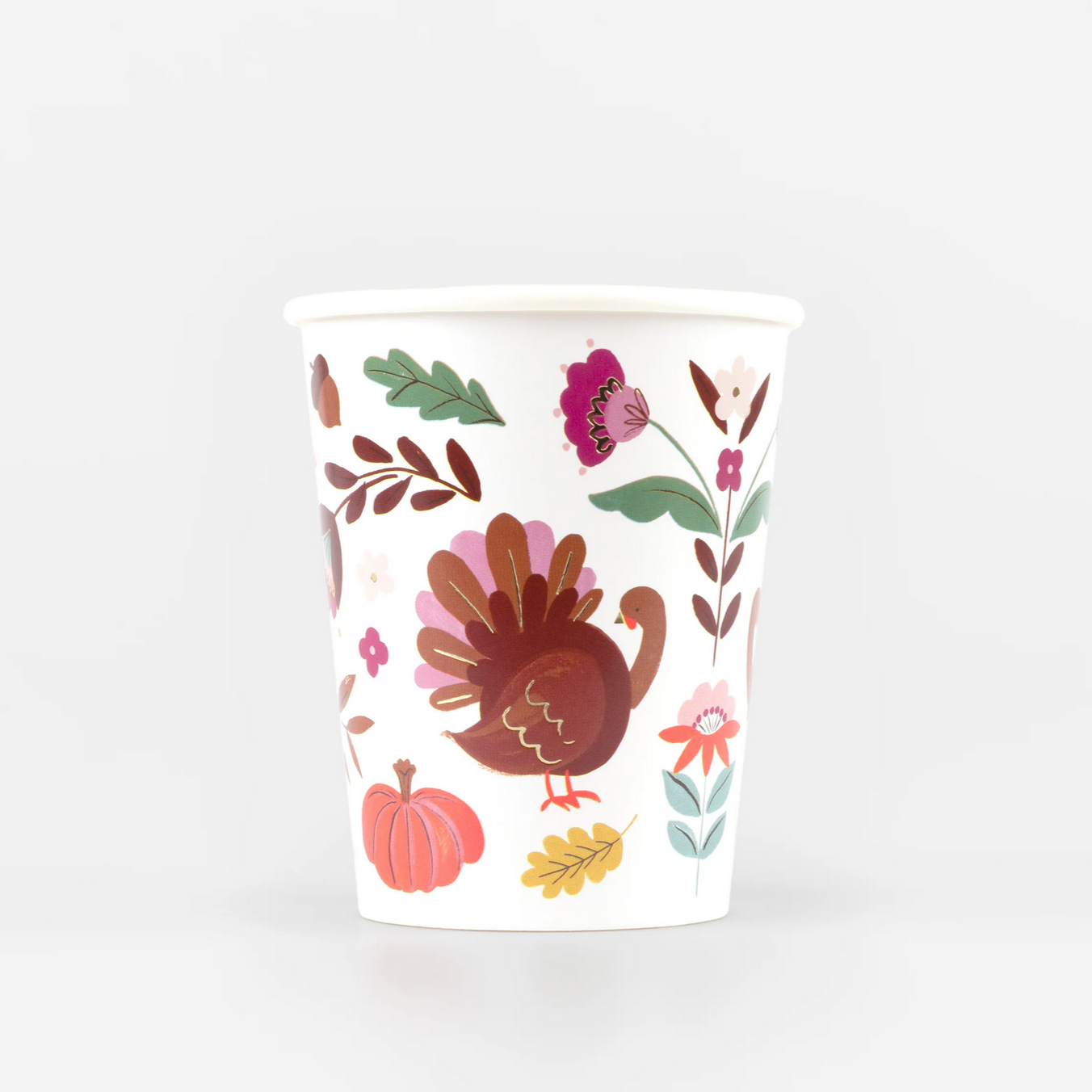 Paper cup with a Thanksgiving-themed design featuring a turkey, pumpkins, and leaves on a white background.