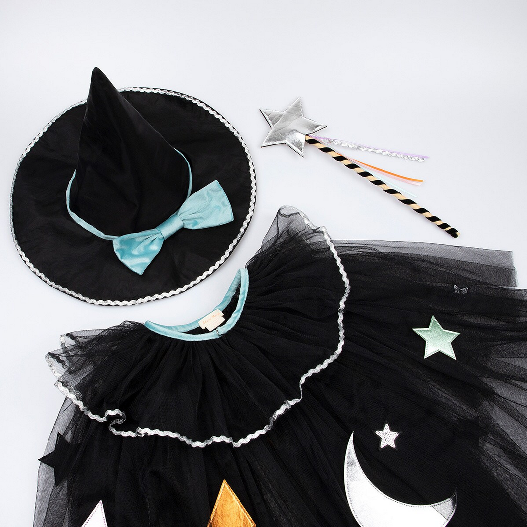 Black witch costume with hat, skirt, and wand on a white background