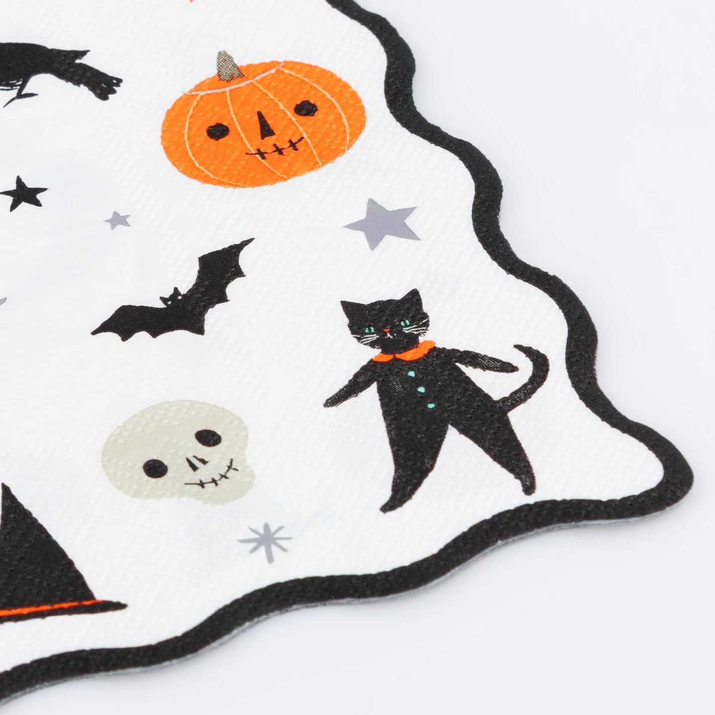 Halloween-themed fabric with black cat, pumpkin, bats, and stars on a white background