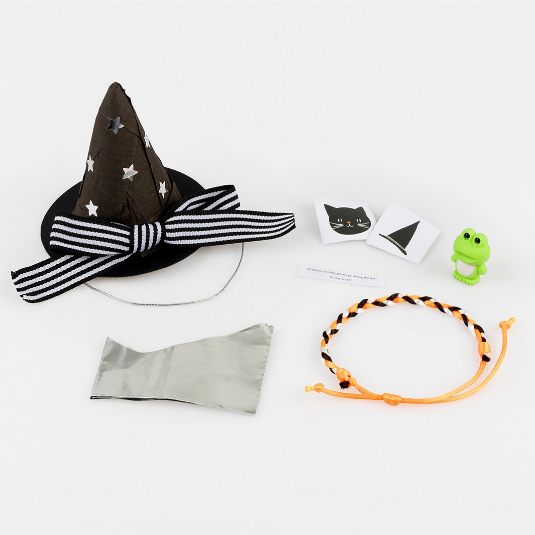 Halloween-themed items including a witch hat, bow tie, and accessories on a white background