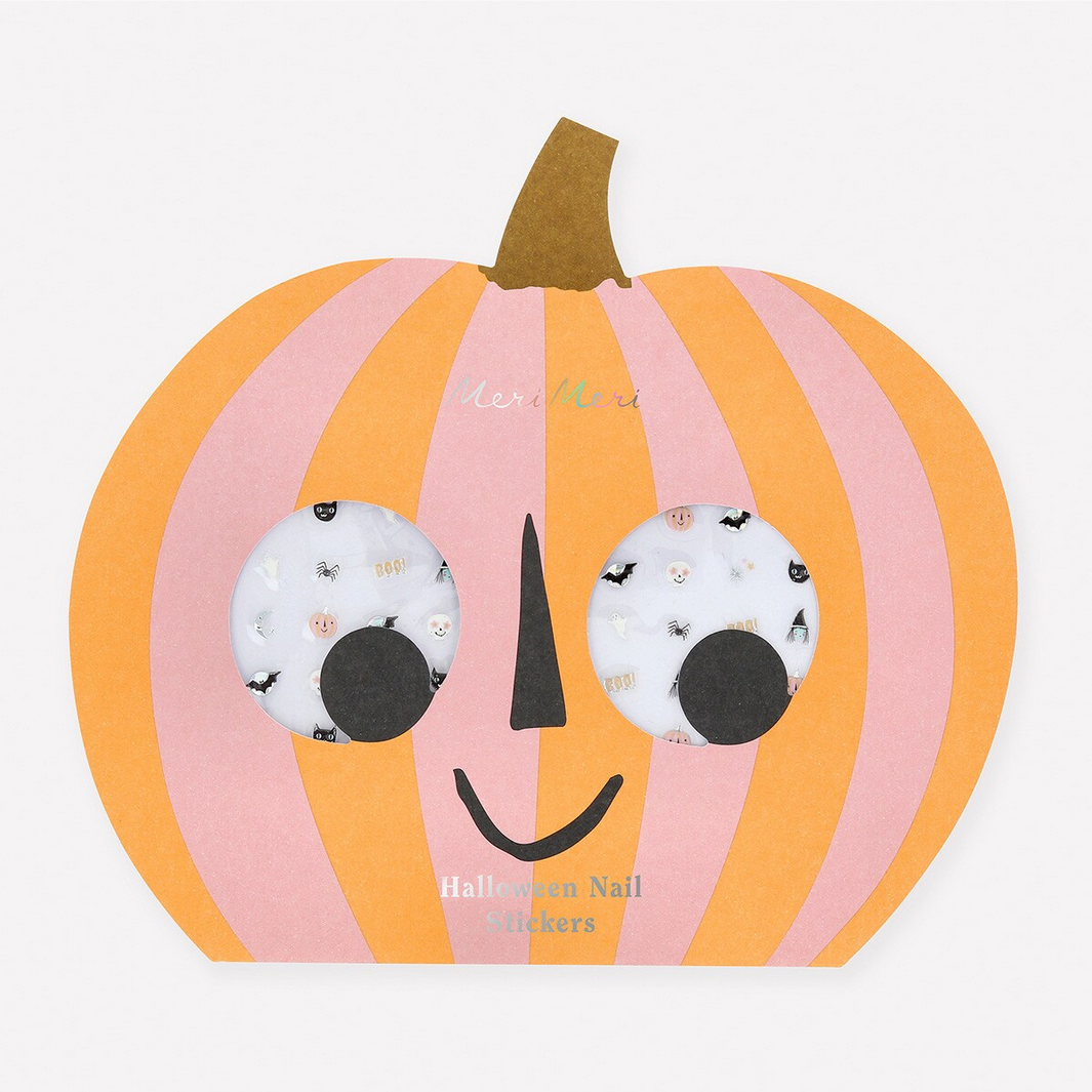 Pumpkin-shaped container with Halloween nail stickers on a white background