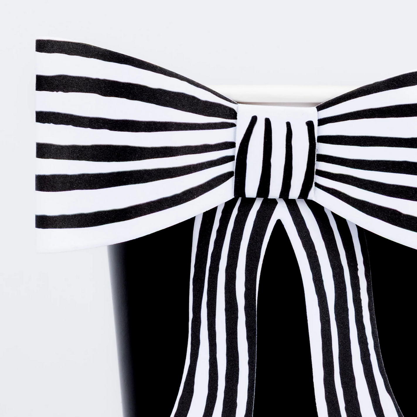 Black and white striped bow on a plain background