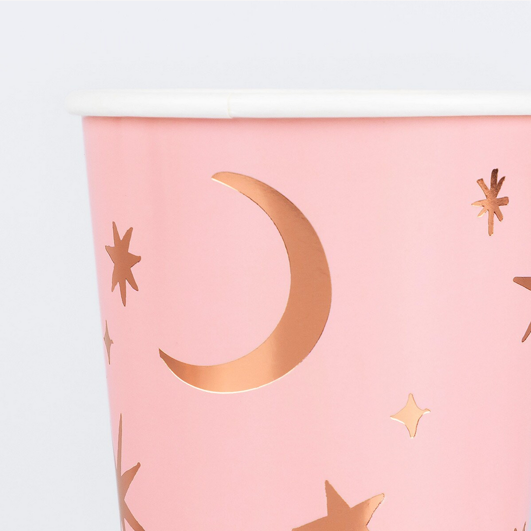 Pink paper with gold moon and star designs on a white background