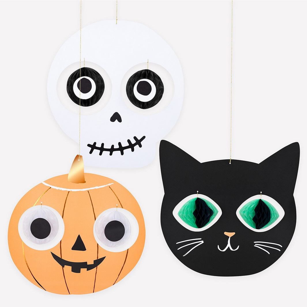 Halloween-themed decorations including a pumpkin, skull, and black cat on a white background.