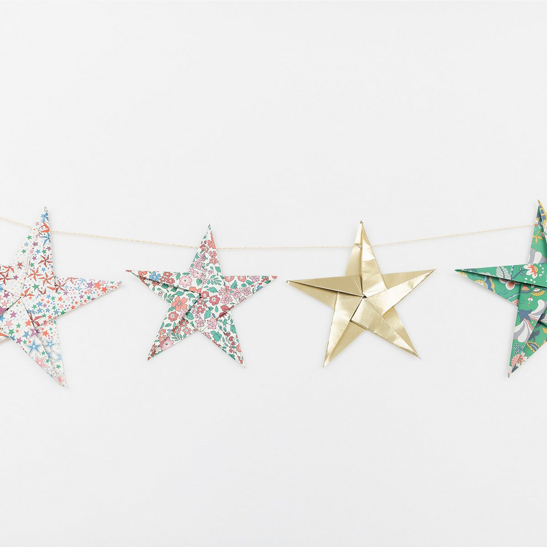 Star-shaped decorative items on a string against a white background