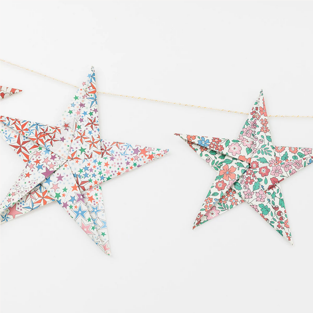Decorative star-shaped flags with floral patterns on a white background