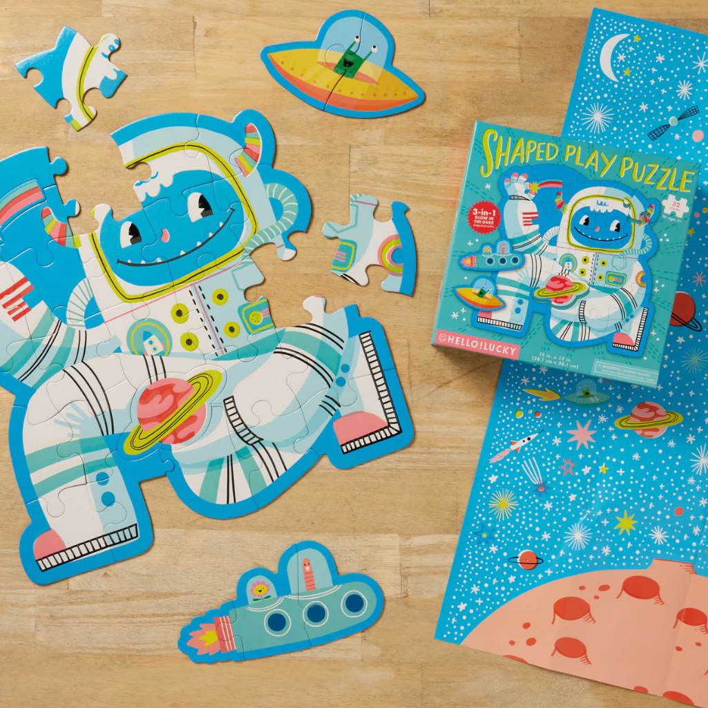 Children's puzzle set with astronaut design on a wooden surface