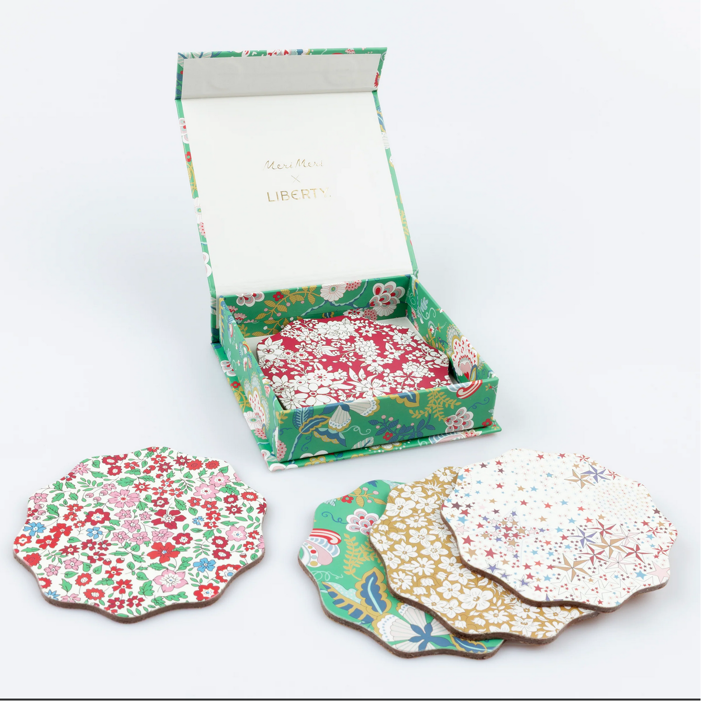 Set of floral coasters with a matching box on a white background