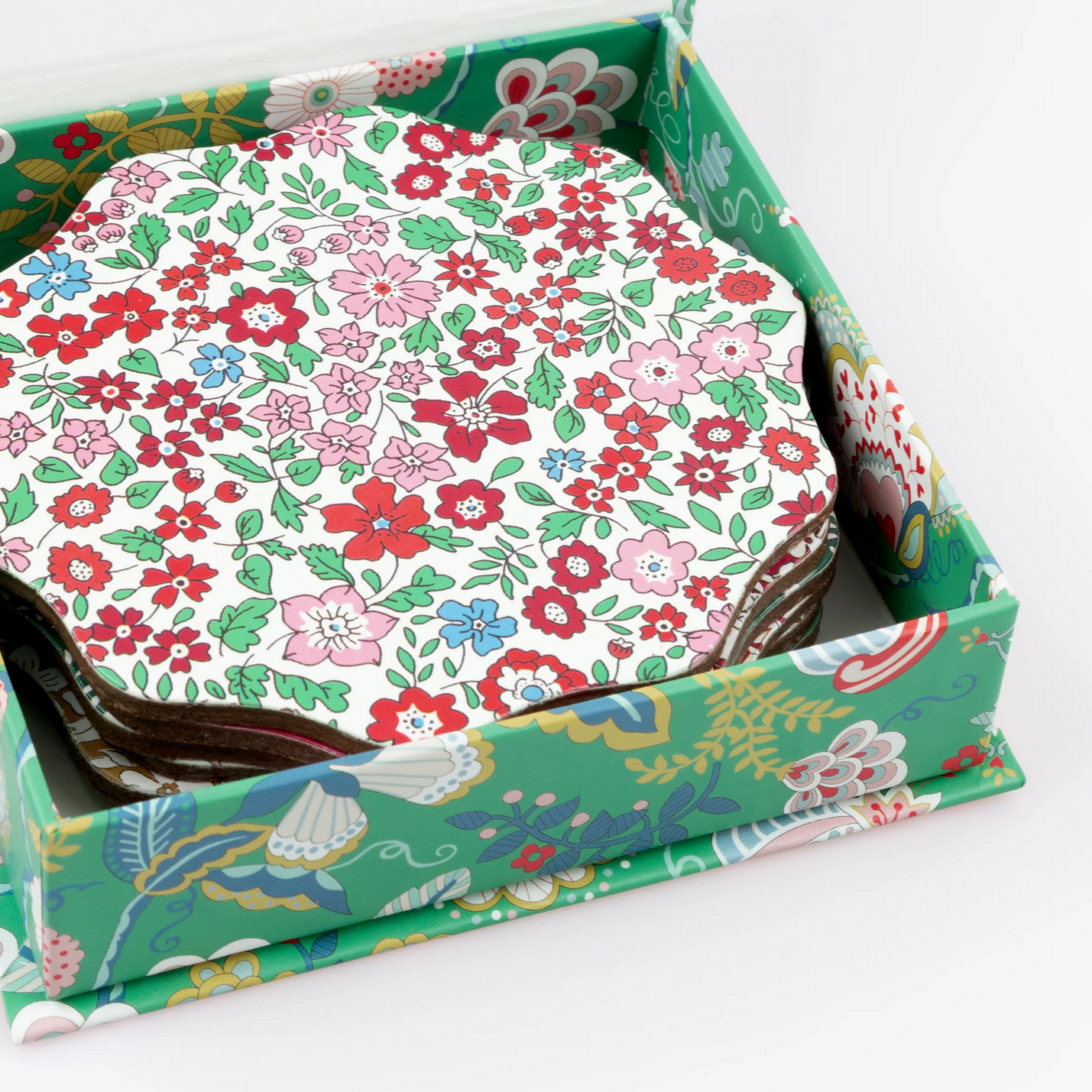 Set of floral coasters in a matching box on a white background