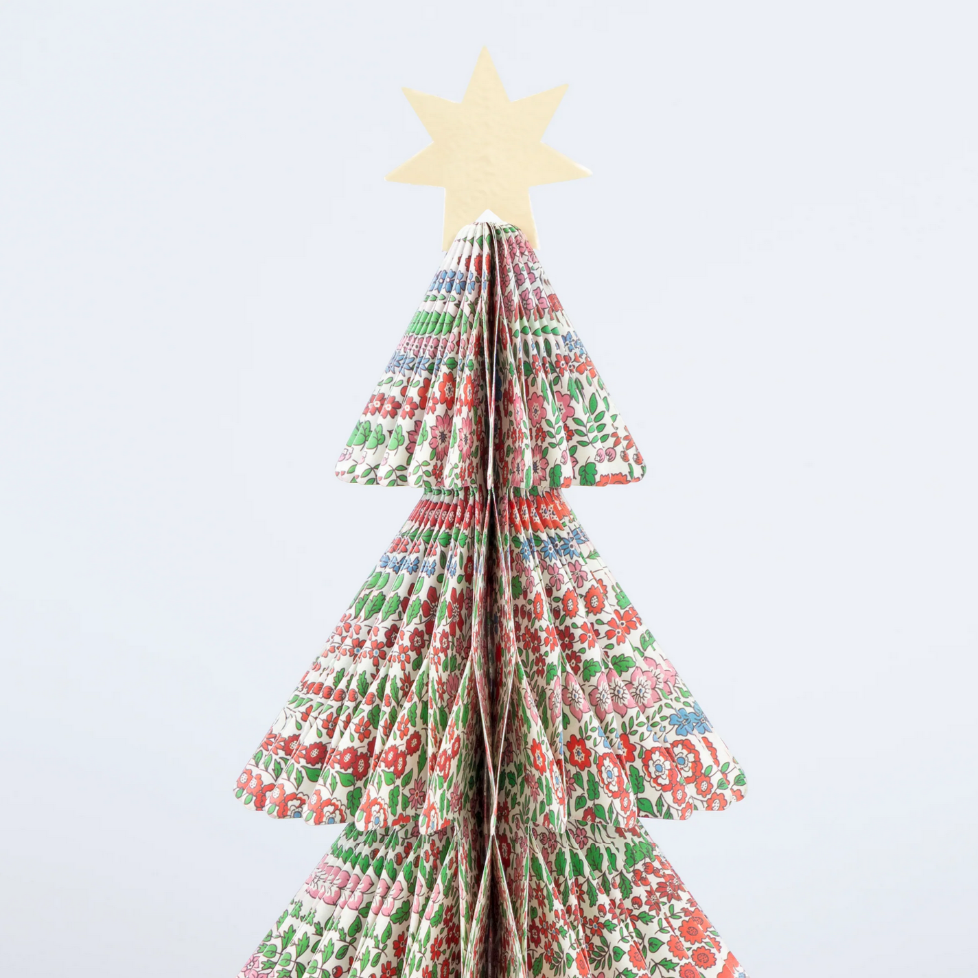 Decorative paper Christmas tree with a star on a white background