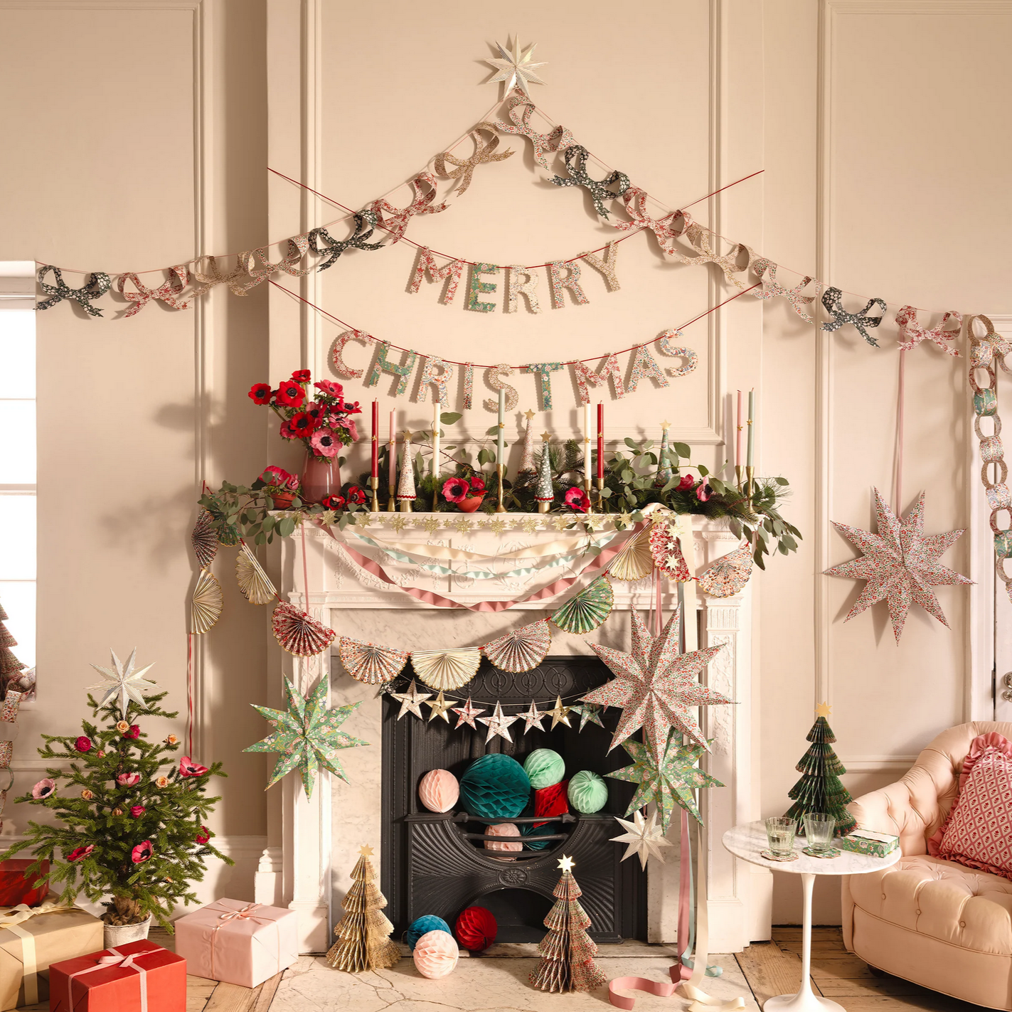 Decorated living room with Christmas decorations, including a fireplace, garlands, and presents.