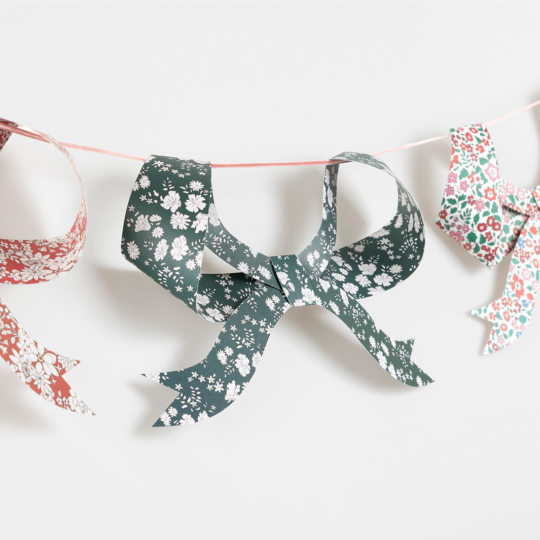 Decorative paper bow with floral pattern on a white background
