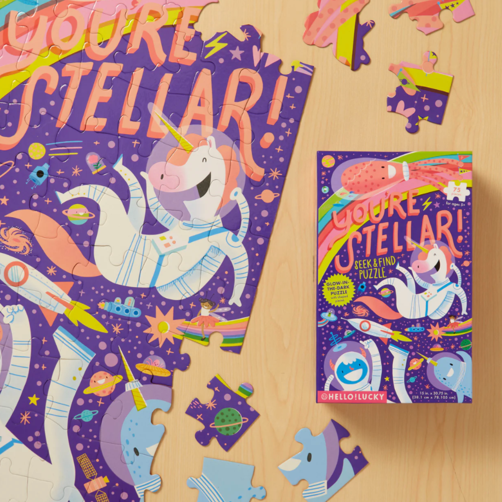 Unicorn-themed puzzle with packaging on a wooden surface