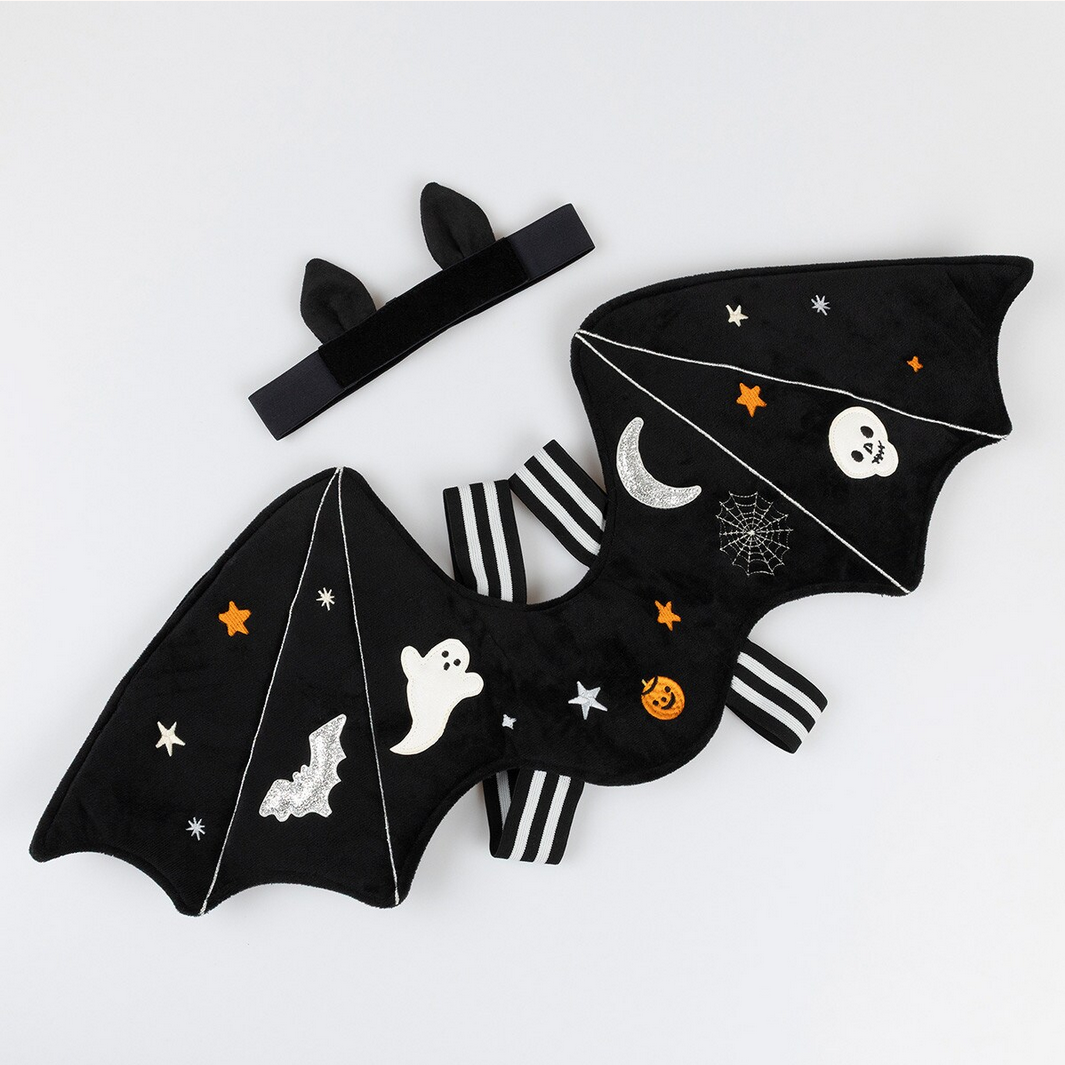 Black bat-shaped wings with Halloween designs on a white background