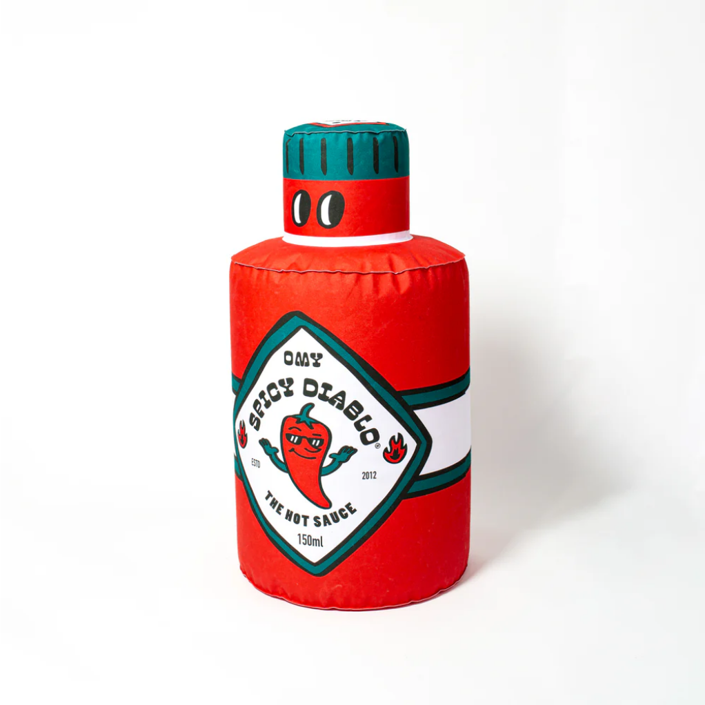 Red bottle-shaped cushion with a green cap on a white background