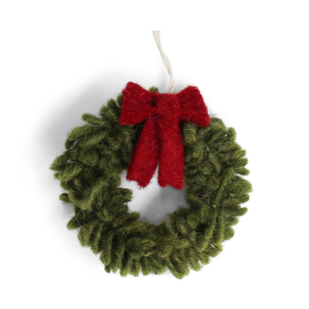 Green Christmas wreath with a red bow on a white background