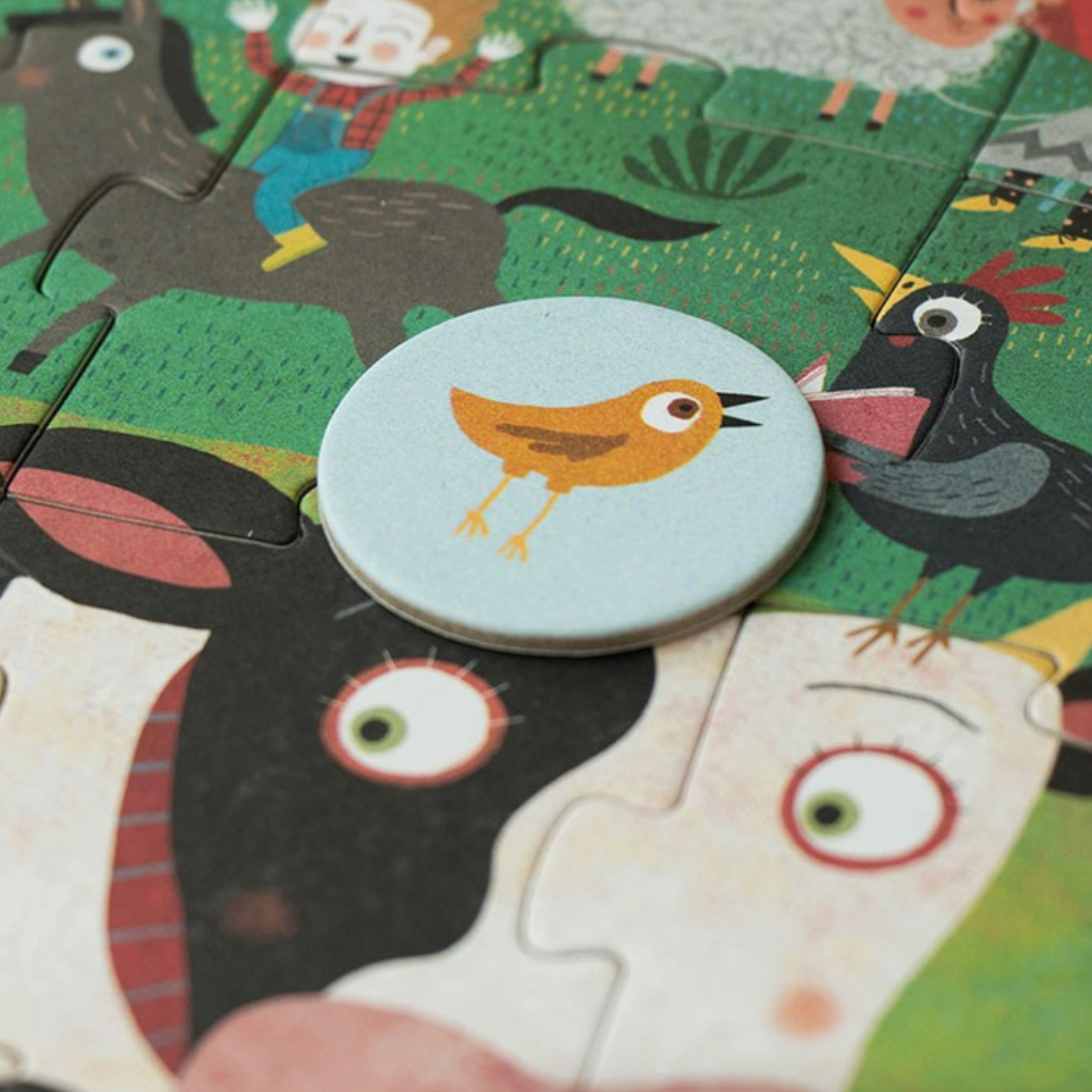 Children's puzzle with cartoon animals on a green background