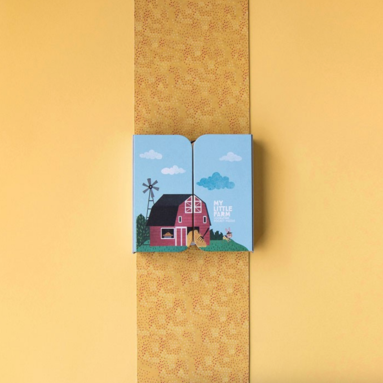 Small book with a farm illustration on a yellow background