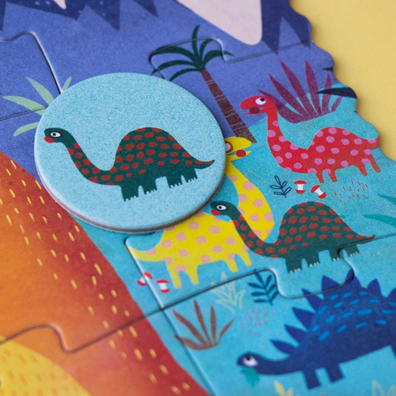 Children's puzzle with colorful dinosaur illustrations on a blue background