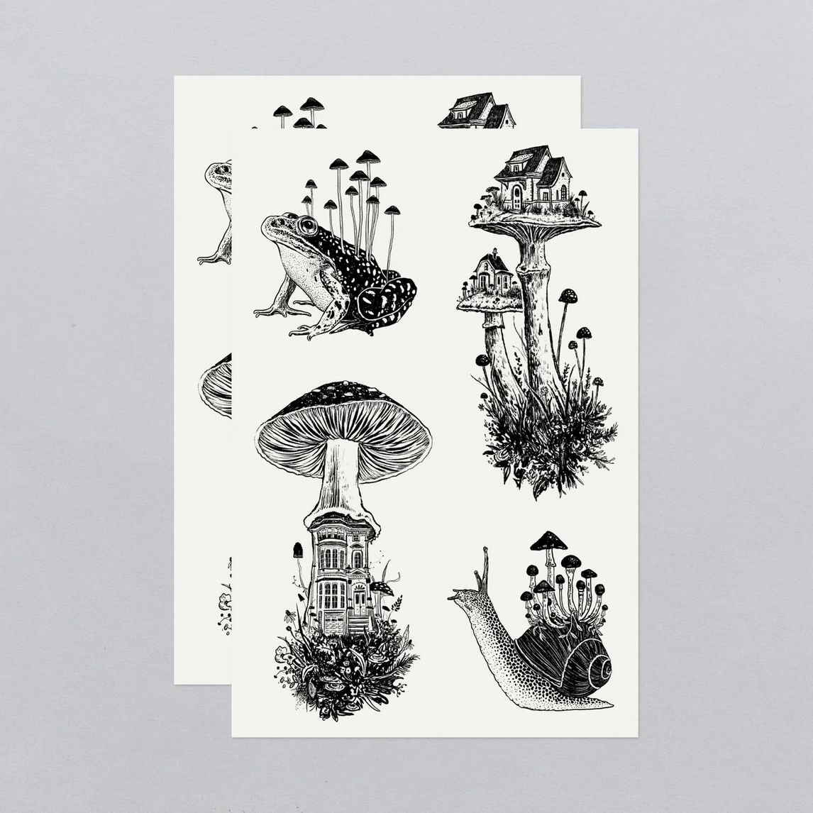 Sheet of black and white temporary tattoos featuring nature-themed designs on a gray background.