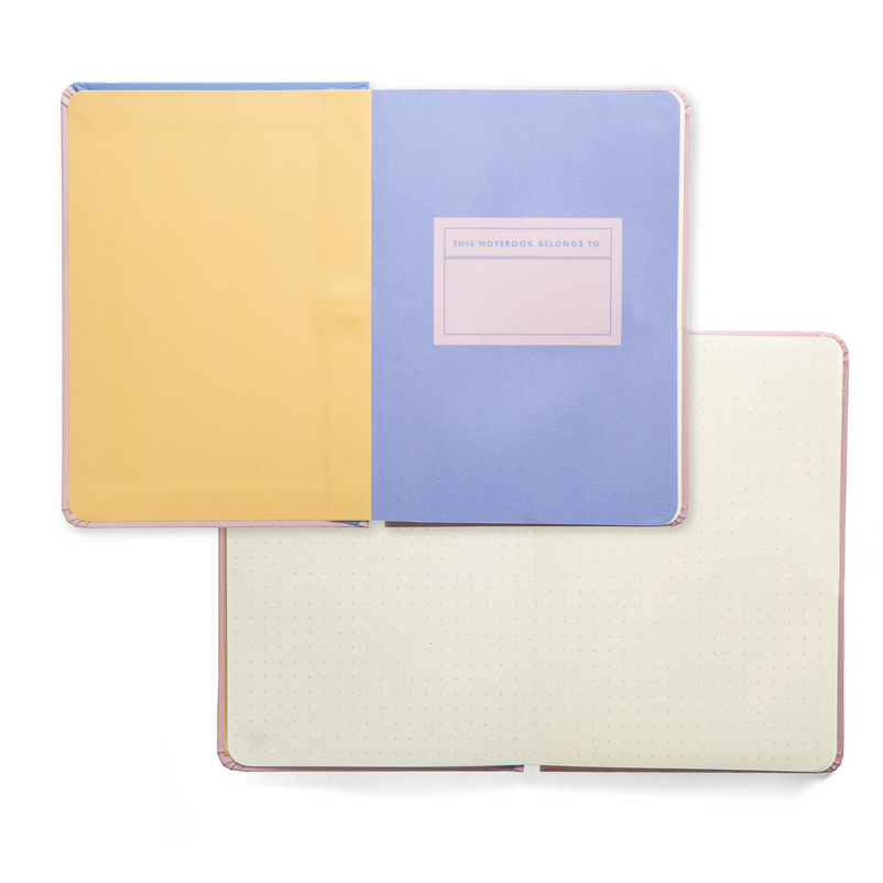 Three notebooks with different colored covers on a white background
