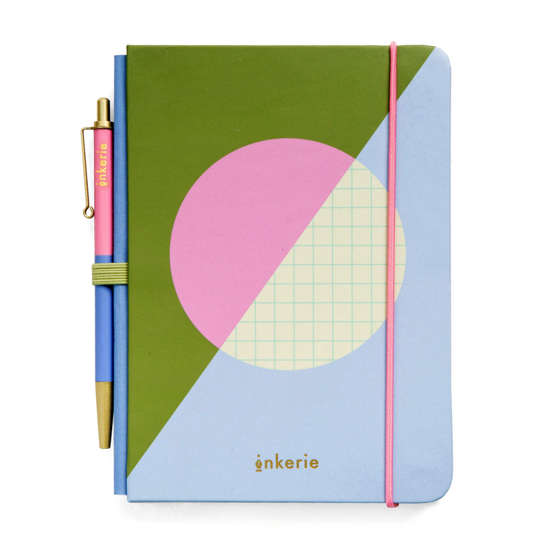 Notebook with geometric design and pen holder on a white background