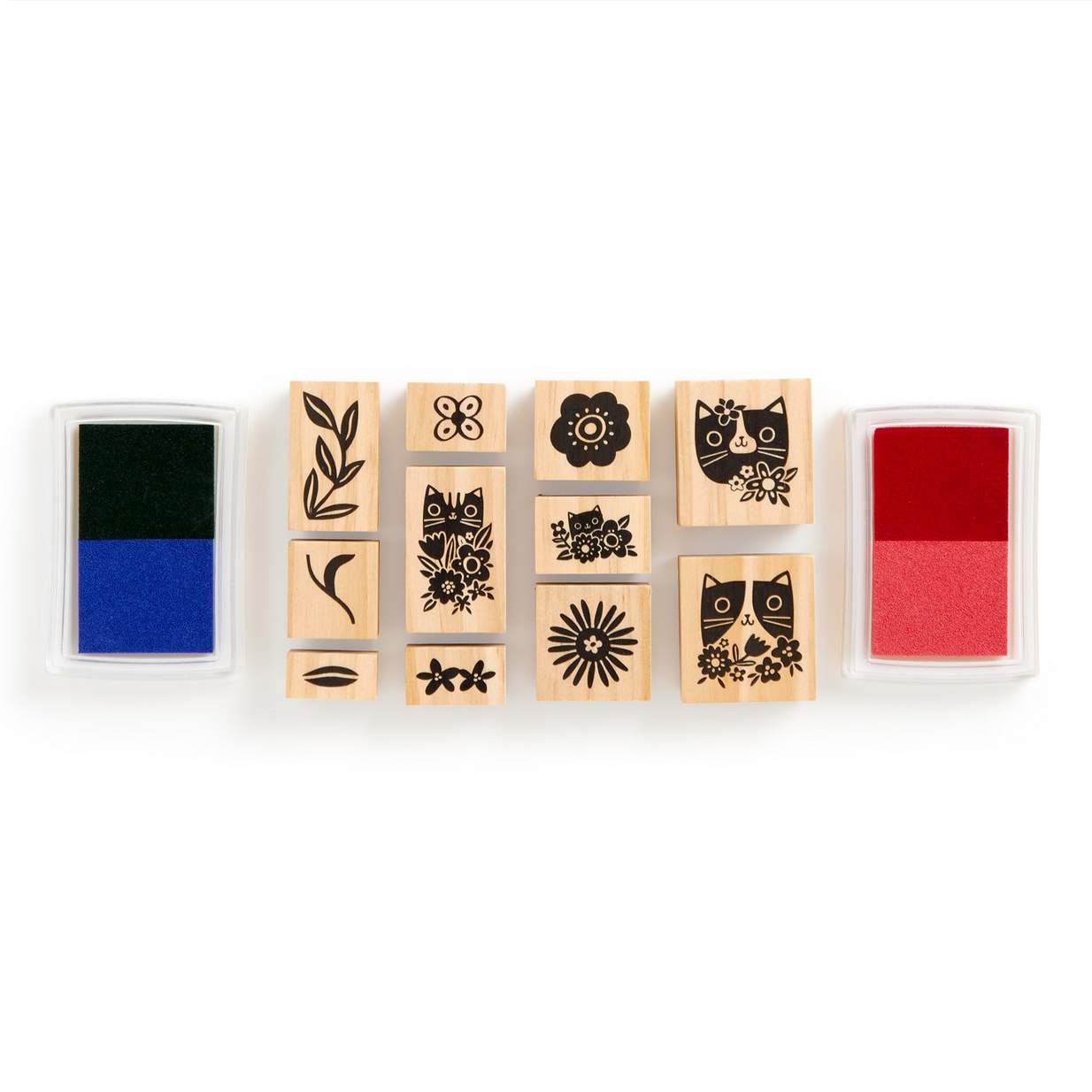Set of wooden stamps with various designs and ink pads on a white background