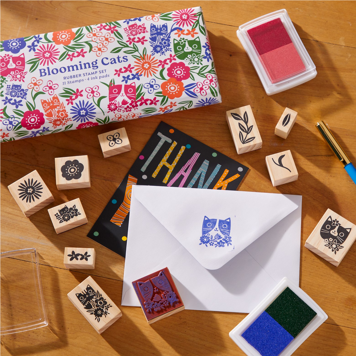Rubber stamp set with 'Blooming Cats' theme on a wooden surface