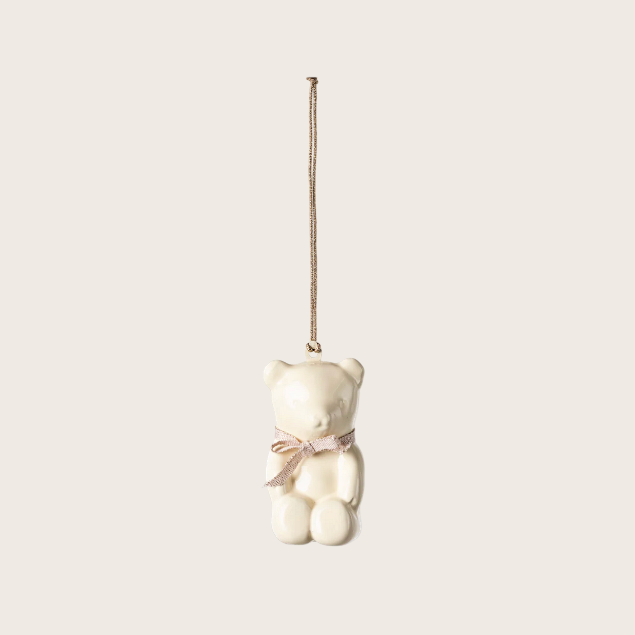 White teddy bear ornament with a pink bow on a white background