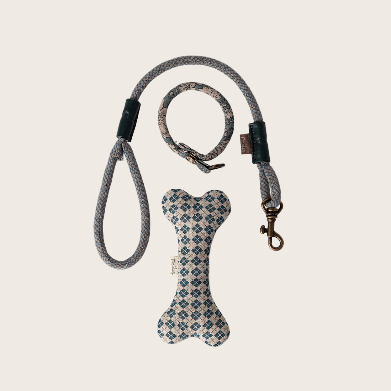 Dog leash and bone-shaped toy with pattern on a beige background