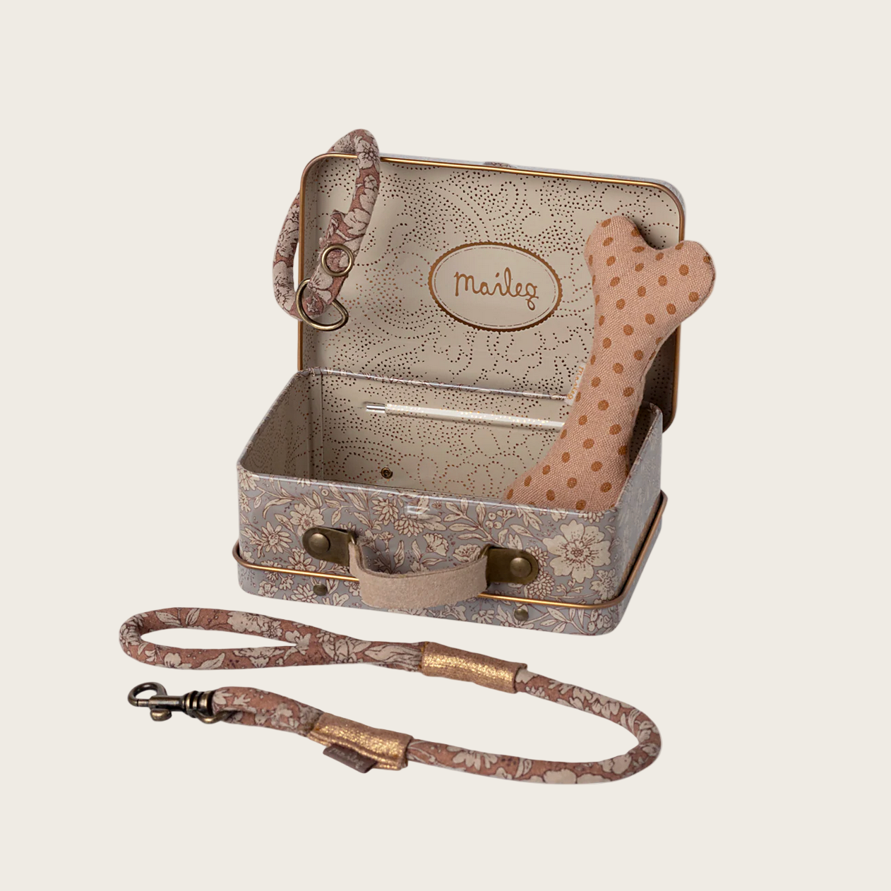 Dog toy set with suitcase, bone, and leash on a website page