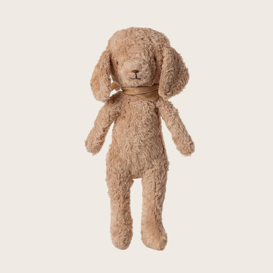 Beige plush dog toy on a light beige background