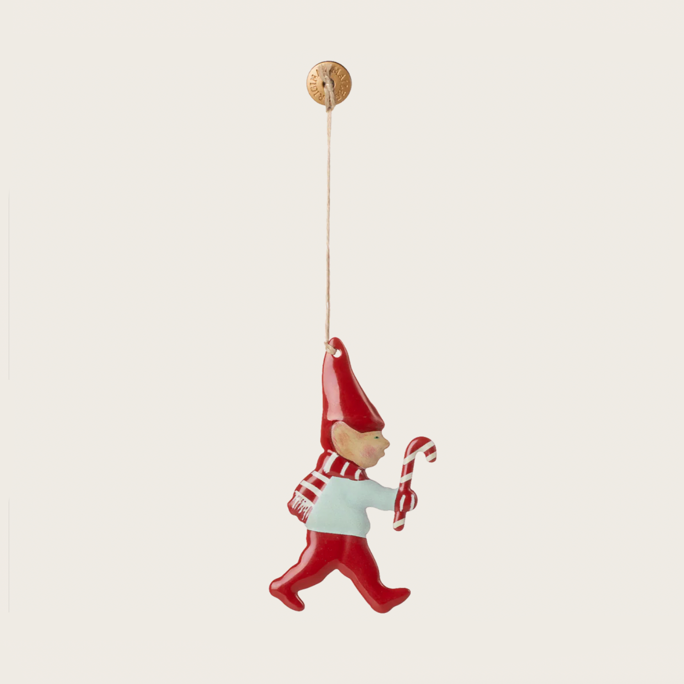 Red gnome ornament with a candy cane on a white background