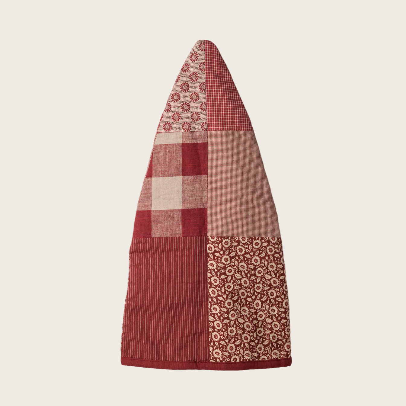 Decorative pixie hat with red and beige pattern on a white background