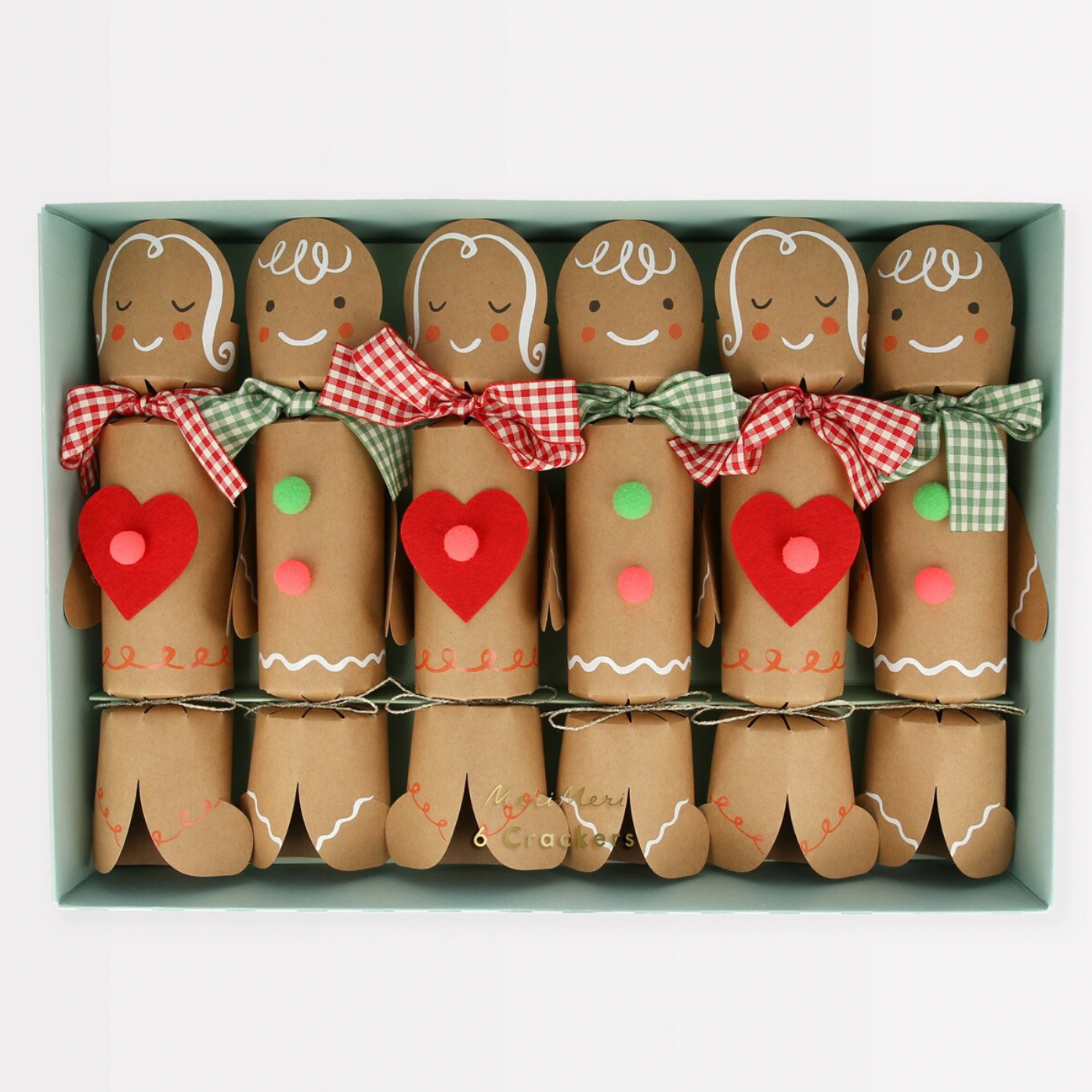 A box of six gingerbread crackers with decorations such as gingham ribbons, pom poms, and felt hearts, each with a paper race track and a joke inside.