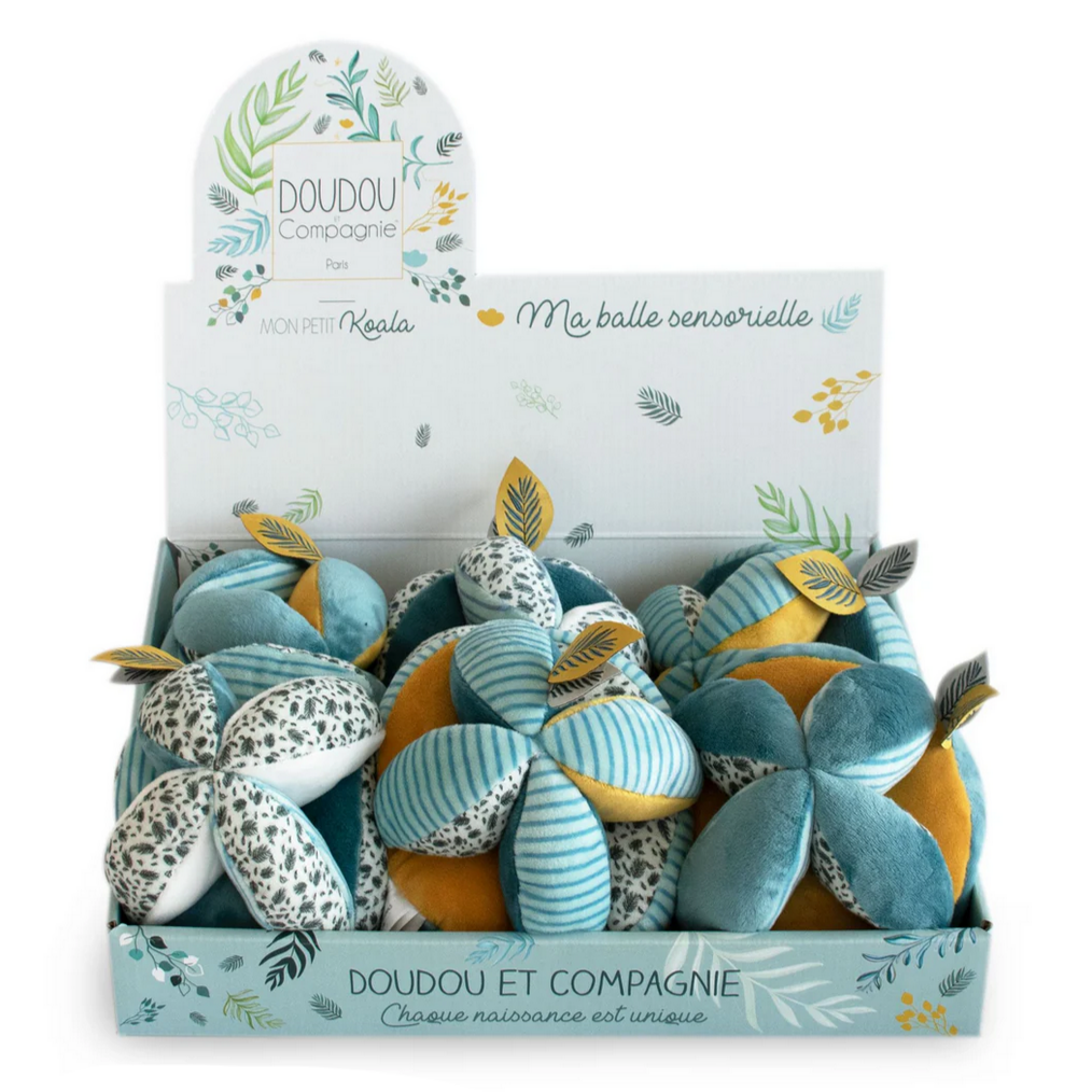 Display of blue and orange plush toys with packaging labeled 'Doudou et Compagnie' on a white background.