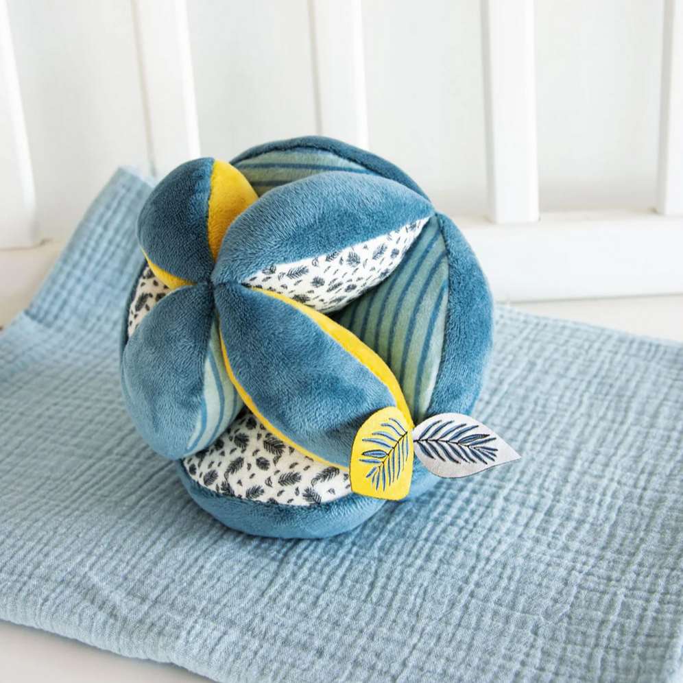 Decorative ball with leaf patterns on a textured surface